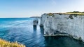 Old Harry Rocks chalk formations, view at Handfast Point, Dorset, southern England. Huge wall of white chalk cliffs with stumps Royalty Free Stock Photo