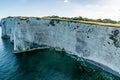 Old Harry Rocks chalk formations, view at Handfast Point, Dorset, southern England. Huge wall of white chalk cliffs with stumps Royalty Free Stock Photo