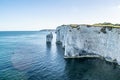 Old Harry Rocks chalk formations, view at Handfast Point, Dorset, southern England. Huge wall of white chalk cliffs with stumps Royalty Free Stock Photo