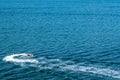 Old Harry Rocks, Dorset, United Kingdom - 16 July 2020: A boy driving water scooter on the sea by the Old Harry Rock, fun activity Royalty Free Stock Photo