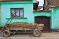 Old hay cart near local vintage house, Romania Royalty Free Stock Photo