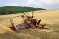 Old hay rake reaper-binder - rustic, oldfashioned farm equipment, used for field works during harvest season.