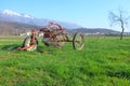 Old hay tedder in a green meadow Royalty Free Stock Photo