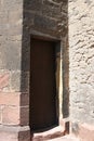 Old heavy square, wooden, massive door in stone wall to enter St. Martin`s Church Royalty Free Stock Photo