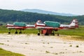 Old helicopter rotor plane on a green airfield.