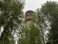 Old high water tower surrounded by trees. Brick tower in countryside. Royalty Free Stock Photo