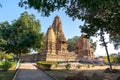 Old Hindu temple, built by Chandela Rajputs, at Western site in India`s Khajuraho framed by trees. Royalty Free Stock Photo