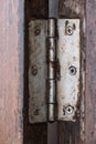 Old hinge on wooden door or window Royalty Free Stock Photo