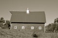 Old hip roof barn with a lone cupola Royalty Free Stock Photo