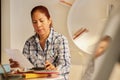 Old Hispanic Woman Filing Forms For Tax Return At Home