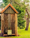 Old Historic Australian Toilet, Outhouse, Dunny on Green Grass. Royalty Free Stock Photo