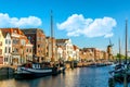 Old historic district Delfshaven with wildmill and houseboats in Rotterdam, South Holland, The Netherlands. Summer sunny day