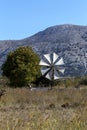 Old, historic, famous, metallic windmills who pump water out of the ground for irrigation of fields on a sunny day Lassithi area