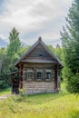 Old historic log house in rural Russia, Siberia surrounded by summer forest. Royalty Free Stock Photo