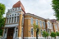 An old historic red brick building with a tiled roof. A red five-pointed star adorns the facade of the History Museum building Royalty Free Stock Photo