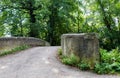 Old historic stone bridge at walk path in park hike trail at water channels in Woking, Surrey, England