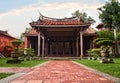 Old historic temple with bonsai alley in front. Traditional red chinese architecture