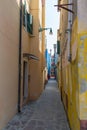 Old, historic, very narrow street with colorful old houses and cobblestone pavement. Venice, Italy Royalty Free Stock Photo