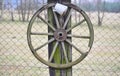 Old historic wagon wheel adorns the fence, South Bohemia