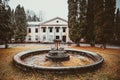 Old, historical, abandoned building Baldone sanatorium and non - working fountain with fish sculptures, Latvia