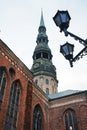 Old historical building with a clock tower next to a street lamp in gloomy weather Royalty Free Stock Photo