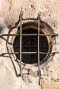 Old historical building with a lattice made of steel in front of the round window Royalty Free Stock Photo