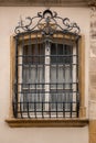 Old historical building with a lattice made of steel in front of the window