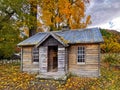 An old historical cottage with autumn trees and cloudy sky Royalty Free Stock Photo