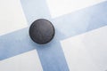 Old hockey puck is on the ice with finland flag Royalty Free Stock Photo
