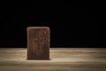 Holy Bible on a wooded table. Black background Royalty Free Stock Photo