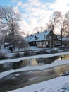 Old home near river in winter, Lithuania Royalty Free Stock Photo