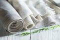 Old homespun and modern factory linen fabrics in rolls and blooming flax Royalty Free Stock Photo