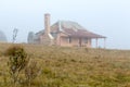 Old homestead in thick morning fog Royalty Free Stock Photo