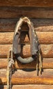 Old horse collar on a log wall. main part of the harness put on the horse neck