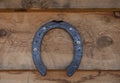 Old horseshoe hanging on the wooden wall.