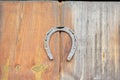 An old horseshoe hangs on the front doors at the entrance to the house Royalty Free Stock Photo