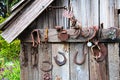 Old Horseshoes and Rusted Tools on Rustic Shack Royalty Free Stock Photo