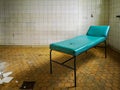 Old hospital bed standing in empty room in old hospital Royalty Free Stock Photo