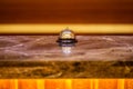 Old hotel bell on a marble stand Royalty Free Stock Photo