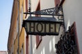 Old hotel sign made of metall on a medieval fascade