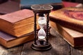 Old hourglass with books Royalty Free Stock Photo