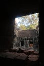 Old house in ancient angkor wat temple ruins seen through window in cambodia, asia Royalty Free Stock Photo