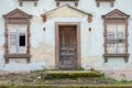 Old house with broken and boarded up shutters