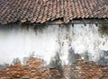 An old house, with broken tiles, demage and vintage brick wall texture for background or wallpaper Royalty Free Stock Photo