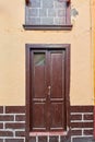 Old house or church with peeling paint on wall or window and wooden shutter door. Vintage and aged residential building Royalty Free Stock Photo