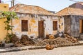 An old house on a cobblestone street with firewood in front of the door, Fogo, Cape Verde