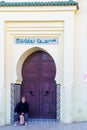 Old house door and a local, in Meknes