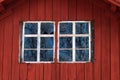 Old house facade with broken window panes from a typical red Swedish house Royalty Free Stock Photo