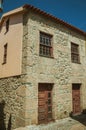 Old house facade made of rough stone on deserted alley Royalty Free Stock Photo