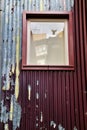 Old house facade with rusty balcony and green blind Royalty Free Stock Photo